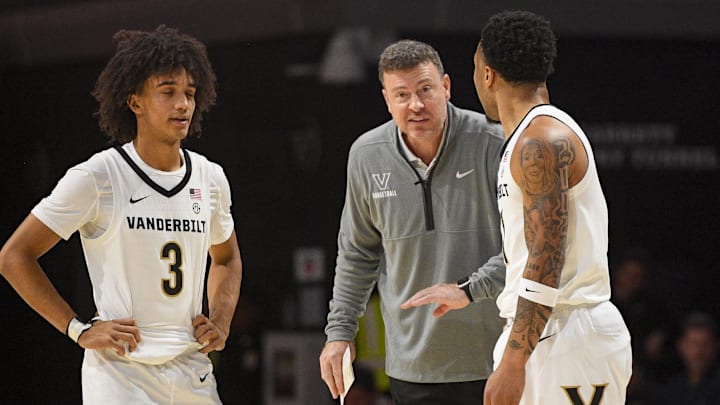 Dec 3, 2025; Nashville, Tennessee, USA;  Vanderbilt Commodores head coach Mark Byington talks with guard Tyler Tanner (3) and guard Frankie Collins (1) against the Southern Methodist University Mustangs during the first half at Memorial Gymnasium. Mandatory Credit: Steve Roberts-Imagn Images