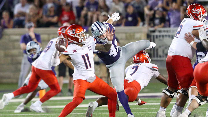 Sep 13, 2024; Manhattan, Kansas, USA; Arizona Wildcats quarterback Noah Fifita (11) passes the ball while being rushed by Kansas State Wildcats linebacker Austin Moore (41) at Bill Snyder Family Football Stadium. Mandatory Credit: Scott Sewell-Imagn Images