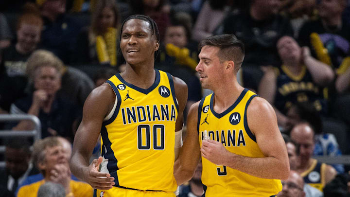 Oct 21, 2022; Indianapolis, Indiana, USA; Indiana Pacers guard Bennedict Mathurin (00) and guard T.J. McConnell (9) after a foul in the first half against the San Antonio Spurs at Gainbridge Fieldhouse. Mandatory Credit: Trevor Ruszkowski-Imagn Images