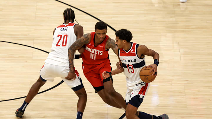 Nov 11, 2024; Houston, Texas, USA;  Washington Wizards forward Alexandre Sarr (20) sets a pick for guard Jordan Poole (13) against Houston Rockets forward Jabari Smith Jr. (10) in the second half at Toyota Center. Mandatory Credit: Thomas Shea-Imagn Images