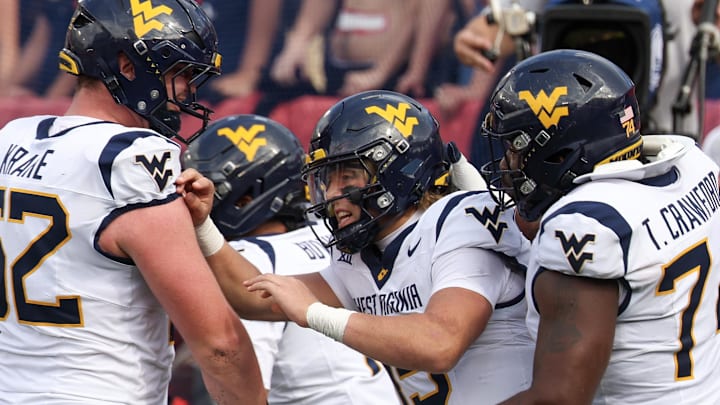 Nov 1, 2025; Houston, Texas, USA; West Virginia Mountaineers quarterback Scotty Fox Jr. (15) celebrates his touchdown with teammates against the Houston Cougars  in the second half at TDECU Stadium. Mandatory Credit: Thomas Shea-Imagn Images