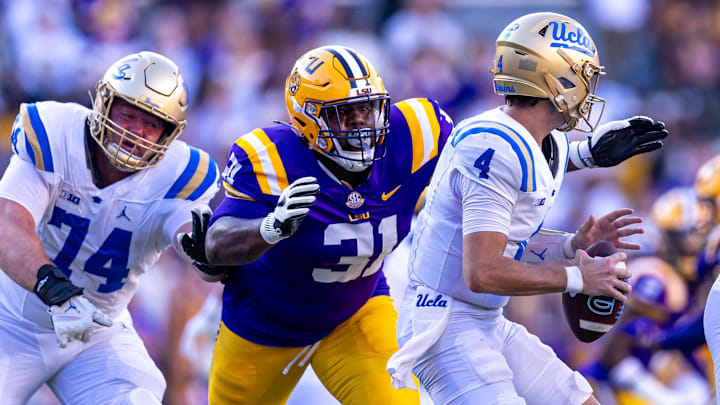 Sep 21, 2024; Baton Rouge, Louisiana, USA;  LSU Tigers defensive tackle Jay'viar Suggs (31) evades UCLA Bruins offensive lineman Spencer Holstege (74) to sack quarterback Ethan Garbers (4) during the second half at Tiger Stadium. Mandatory Credit: Stephen Lew-Imagn Images