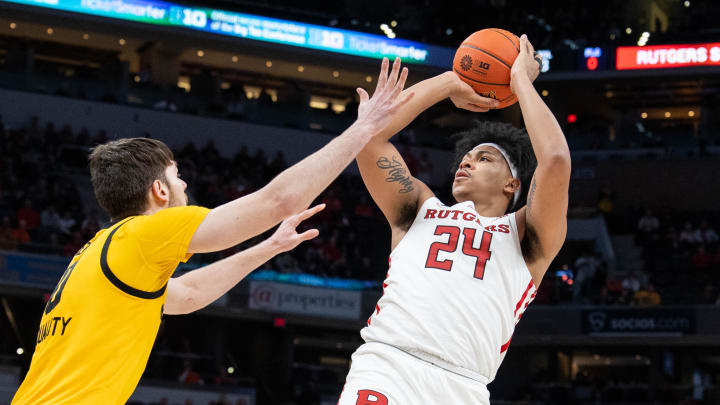 Mar 11, 2022; Indianapolis, IN, USA; Rutgers Scarlet Knights forward Ron Harper Jr. (24) shoots the ball while Iowa Hawkeyes forward Filip Rebraca (0) defends in the second half at Gainbridge Fieldhouse. Mandatory Credit: Trevor Ruszkowski-USA TODAY Sports