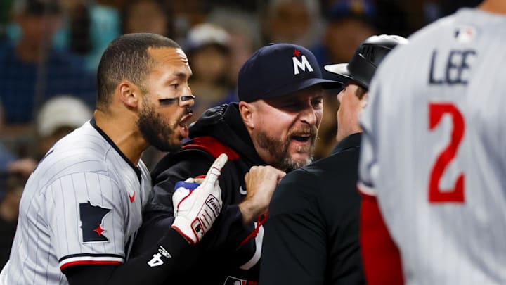 May 31, 2025; Seattle, Washington, USA; Minnesota Twins shortstop Carlos Correa (4, left) and manager Rocco Baldelli (5, middle) argue with umpire Austin Jones (right) during the seventh inning against the Seattle Mariners at T-Mobile Park. Correa and Baldelli were both ejected from the game. Mandatory Credit: Joe Nicholson-Imagn Images