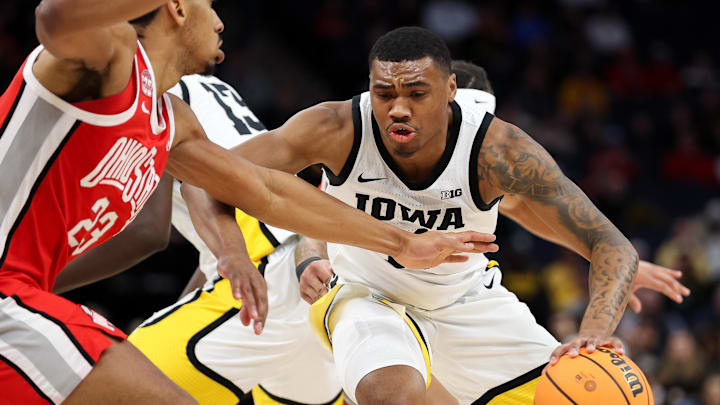 Mar 14, 2024; Minneapolis, MN, USA; Iowa Hawkeyes guard Tony Perkins (11) dribbles as Ohio State