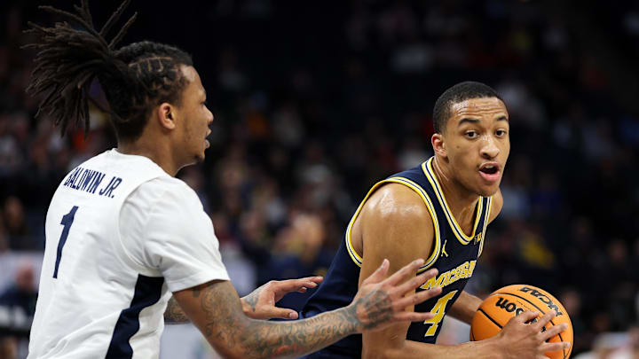 Mar 13, 2024; Minneapolis, MN, USA; Michigan Wolverines guard Nimari Burnett (4) works around Penn