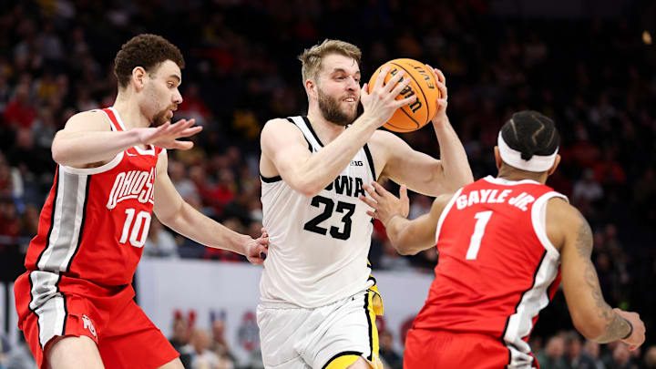 Mar 14, 2024; Minneapolis, MN, USA; Iowa Hawkeyes forward Ben Krikke (23) passes as Ohio State