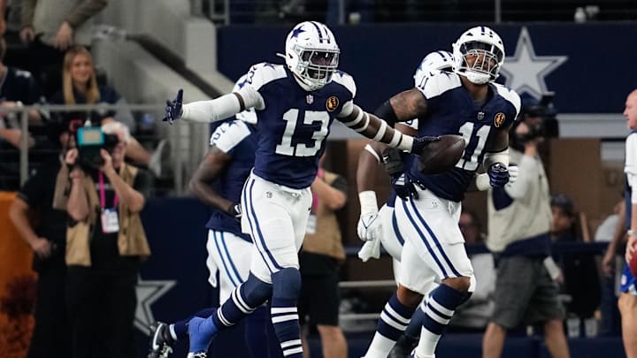 Nov 28, 2024; Arlington, Texas, USA;  Dallas Cowboys linebacker DeMarvion Overshown (13) celebrates after scoring on a touchdown interception against the New York Giants during the first half at AT&T Stadium. Mandatory Credit: Chris Jones-Imagn Images