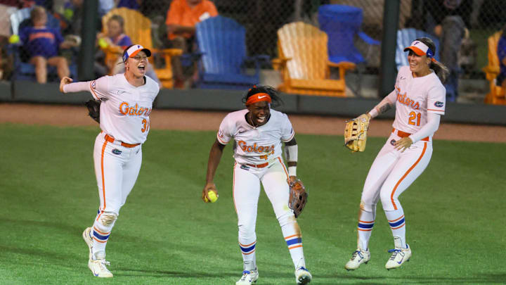 Florida outfielder Townsen Thomas (44), center, celebrates making the winning out against Florida Stat with Florida infielder Kenleigh Cahalan (31) and Florida outfielder Taylor Shumaker (21) during a NCAA softball game at Katie Seashole Pressly Stadium in Gainesville, FL on Tuesday, April 28, 2026. [Alan Youngblood/Gainesville Sun]