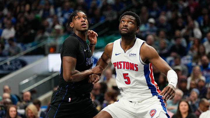 Apr 12, 2024; Dallas, Texas, USA; Dallas Mavericks forward Olivier-Maxence Prosper (18) and Detroit Pistons forward Chimezie Metu (5) battle for position during the first half at American Airlines Center. Mandatory Credit: Chris Jones-Imagn Images