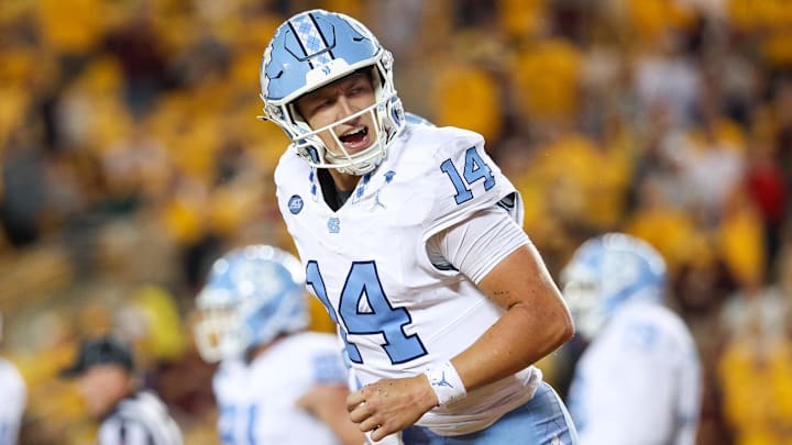 Aug 29, 2024; Minneapolis, Minnesota, USA; North Carolina Tar Heels quarterback Max Johnson (14) celebrates his rushing touchdown against the Minnesota Golden Gophers during the first half at Huntington Bank Stadium. Mandatory Credit: Matt Krohn-Imagn Images
