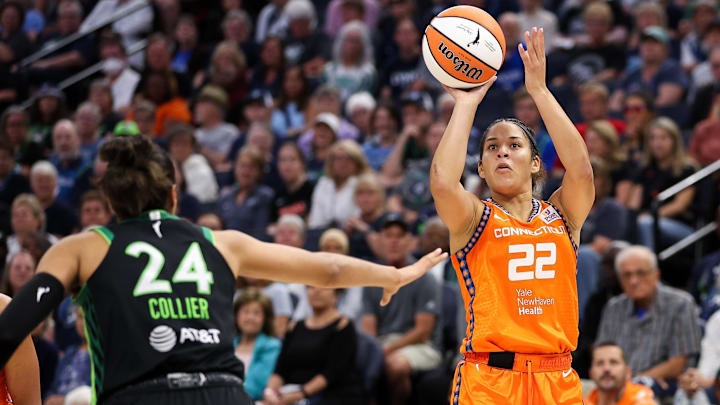 Sep 29, 2024; Minneapolis, Minnesota, USA; Connecticut Sun guard Veronica Burton (22) shoots as Minnesota Lynx forward Napheesa Collier (24) defends during the first half of game one of the 2024 WNBA Semi-finals at Target Center. Mandatory Credit: Matt Krohn-Imagn Images