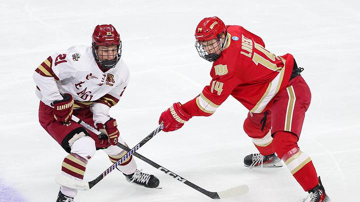 Apr 13, 2024; Saint Paul, Minnesota, USA; Boston College Eagles forward Oskar Jellvik (21) and Denver Pioneers forward Rieger Lorenz (14) compete for the puck during the first period of the championship game of the 2024 Frozen Four college ice hockey tournament at Xcel Energy Center. Mandatory Credit: Matt Krohn-Imagn Images