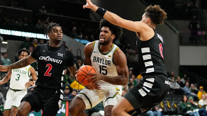 Jan 7, 2025; Waco, Texas, USA; Baylor Bears forward Norchad Omier (15) drives to the basket between Cincinnati Bearcats guard Jizzle James (2) and guard Dan Skillings Jr. (0) during the first half at Paul and Alejandra Foster Pavilion. Mandatory Credit: Chris Jones-Imagn Images Jan 7, 2025; Waco, Texas, USA; Baylor Bears forward Norchad Omier (15) drives to the basket between Cincinnati Bearcats guard Jizzle James (2) and guard Dan Skillings Jr. (0) during the first half at Paul and Alejandra Foster Pavilion. Mandatory Credit: Chris Jones-Imagn Images