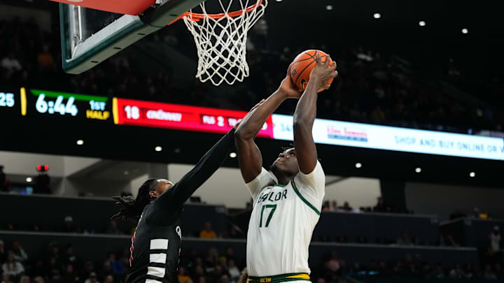 Jan 7, 2025; Waco, Texas, USA; Baylor Bears forward Josh Ojianwuna (17) scores a basket as Cincinnati Bearcats guard Day Day Thomas (1) defends during the first half at Paul and Alejandra Foster Pavilion. Mandatory Credit: Chris Jones-Imagn Images Jan 7, 2025; Waco, Texas, USA; Baylor Bears forward Josh Ojianwuna (17) scores a basket as Cincinnati Bearcats guard Day Day Thomas (1) defends during the first half at Paul and Alejandra Foster Pavilion. Mandatory Credit: Chris Jones-Imagn Images