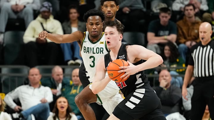 Jan 7, 2025; Waco, Texas, USA; Cincinnati Bearcats guard Simas Lukosius (41) controls the ball as Baylor Bears guard Jeremy Roach (3) defends during the first half at Paul and Alejandra Foster Pavilion. Mandatory Credit: Chris Jones-Imagn Images Jan 7, 2025; Waco, Texas, USA; Cincinnati Bearcats guard Simas Lukosius (41) controls the ball as Baylor Bears guard Jeremy Roach (3) defends during the first half at Paul and Alejandra Foster Pavilion. Mandatory Credit: Chris Jones-Imagn Images