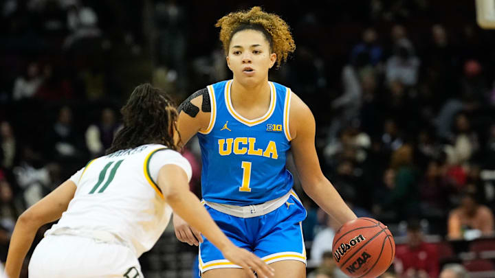 Jan 20, 2025; Newark, New Jersey, USA;  UCLA Bruins guard Kiki Rice (1) controls the ball as Baylor Lady Bears guard Jada Walker (11) defends during the second half at Prudential Center. Mandatory Credit: Chris Jones-Imagn Images