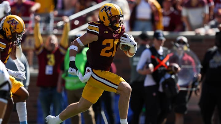 Sep 7, 2024; Minneapolis, Minnesota, USA; Minnesota Golden Gophers defensive back Jack Henderson (20) scores a touchdown after intercepting a pass against the Rhode Island Rams during the second half at Huntington Bank Stadium. Mandatory Credit: Matt Krohn-Imagn Images