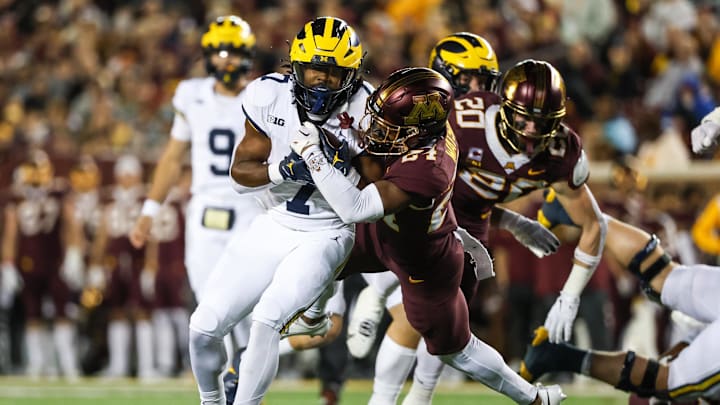 Oct 7, 2023; Minneapolis, Minnesota, USA; Michigan Wolverines running back Donovan Edwards (7) makes a catch while Minnesota Golden Gophers defensive back Tariq Watson (24) defends during the second quarter at Huntington Bank Stadium. Mandatory Credit: Matt Krohn-Imagn Images