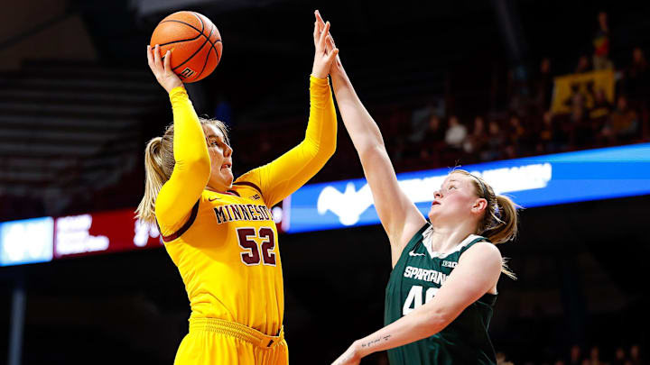 Jan 20, 2024; Minneapolis, Minnesota, USA; Minnesota Golden Gophers center Sophie Hart (52) shoots as Michigan State Spartans guard Julia Ayrault (40) defends during the first half at Williams Arena. Mandatory Credit: Matt Krohn-Imagn Images