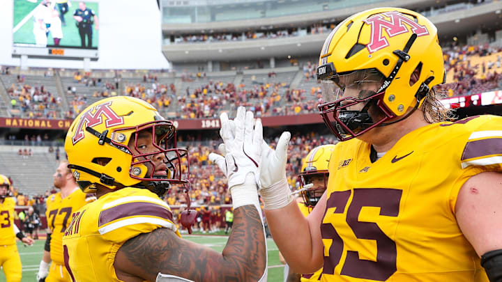 Sep 14, 2024; Minneapolis, Minnesota, USA; Minnesota Golden Gophers running back Darius Taylor (1) and offensive lineman Greg Johnson (65) celebrate their teams win against the Nevada Wolf Pack after the game at Huntington Bank Stadium. Mandatory Credit: Matt Krohn-Imagn Images Sep 14, 2024; Minneapolis, Minnesota, USA; Minnesota Golden Gophers running back Darius Taylor (1) and offensive lineman Greg Johnson (65) celebrate their teams win against the Nevada Wolf Pack after the game at Huntington Bank Stadium. Mandatory Credit: Matt Krohn-Imagn Images