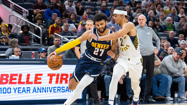 Nov 9, 2022; Indianapolis, Indiana, USA; Denver Nuggets guard Jamal Murray (27) dribbles the ball while Indiana Pacers guard Andrew Nembhard (2) defends in the second half at Gainbridge Fieldhouse. Mandatory Credit: Trevor Ruszkowski-Imagn Images