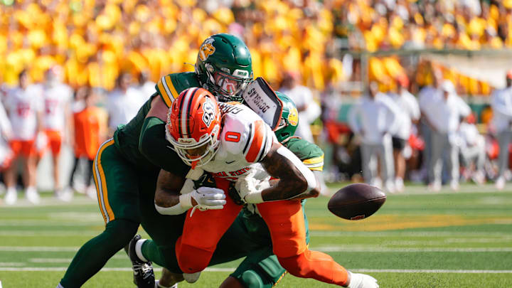 Oct 26, 2024; Waco, Texas, USA; Baylor Bears linebacker Matt Jones (2) punches the ball out of the grasp of Oklahoma State Cowboys running back Ollie Gordon II (0)  during the first half at McLane Stadium. Mandatory Credit: Chris Jones-Imagn Images