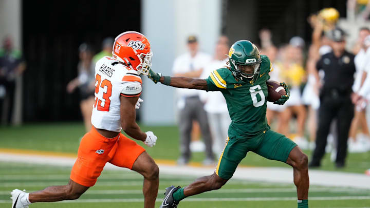 Oct 26, 2024; Waco, Texas, USA;  Baylor Bears wide receiver Ashtyn Hawkins (6) runs the ball after a catch against Oklahoma State Cowboys cornerback Kenneth Harris (23) during the second half at McLane Stadium. Mandatory Credit: Chris Jones-Imagn Images
