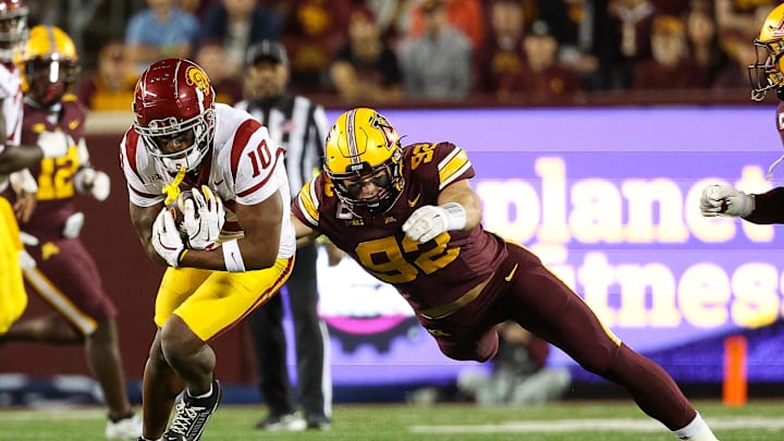 Oct 5, 2024; Minneapolis, Minnesota, USA; USC Trojans wide receiver Kyron Hudson (10) runs after a catch as Minnesota Golden Gophers defensive lineman Danny Striggow (92) defends during the first half at Huntington Bank Stadium. Mandatory Credit: Matt Krohn-Imagn Images Oct 5, 2024; Minneapolis, Minnesota, USA; USC Trojans wide receiver Kyron Hudson (10) runs after a catch as Minnesota Golden Gophers defensive lineman Danny Striggow (92) defends during the first half at Huntington Bank Stadium. Mandatory Credit: Matt Krohn-Imagn Images