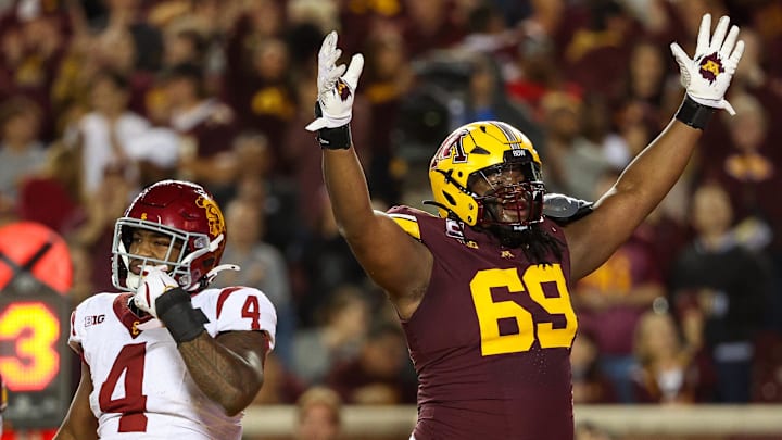 Oct 5, 2024; Minneapolis, Minnesota, USA; Minnesota Golden Gophers offensive lineman Aireontae Ersery (69) celebrates quarterback Max Brosmer's (16) touchdown against the USC Trojans during the first half at Huntington Bank Stadium. Mandatory Credit: Matt Krohn-Imagn Images