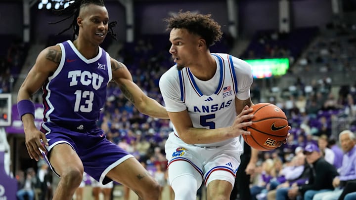 Jan 22, 2025; Fort Worth, Texas, USA; Kansas Jayhawks guard Zeke Mayo (5) controls the ball as TCU Horned Frogs forward Trazarien White (13) defends during the second half at Ed and Rae Schollmaier Arena. Mandatory Credit: Chris Jones-Imagn Images Jan 22, 2025; Fort Worth, Texas, USA; Kansas Jayhawks guard Zeke Mayo (5) controls the ball as TCU Horned Frogs forward Trazarien White (13) defends during the second half at Ed and Rae Schollmaier Arena. Mandatory Credit: Chris Jones-Imagn Images