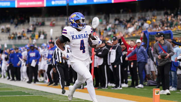 Nov 30, 2024; Waco, Texas, USA;  Kansas Jayhawks running back Devin Neal (4) runs the ball for a touchdown against the Baylor Bears during the first half at McLane Stadium. Mandatory Credit: Chris Jones-Imagn Images