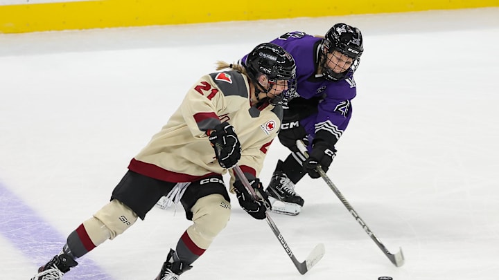 Jan 6, 2024; St. Paul, Minnesota, USA; Montreal forward Tereza Vanisova  (21) and Minnesota forward Kendall Coyne (26) compete for the puck during the first period in a PWHL ice hockey game at XCel Energy Center. Mandatory Credit: Matt Krohn-Imagn Images