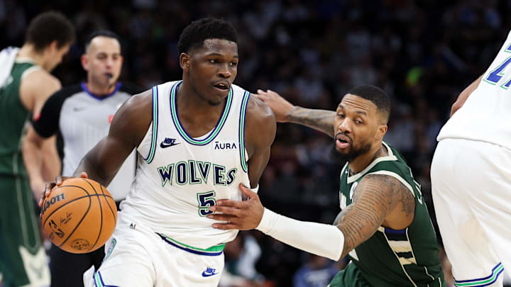 Feb 23, 2024; Minneapolis, Minnesota, USA; Minnesota Timberwolves guard Anthony Edwards (5) works around Milwaukee Bucks guard Damian Lillard (0)  during the second half at Target Center. Mandatory Credit: Matt Krohn-Imagn Images