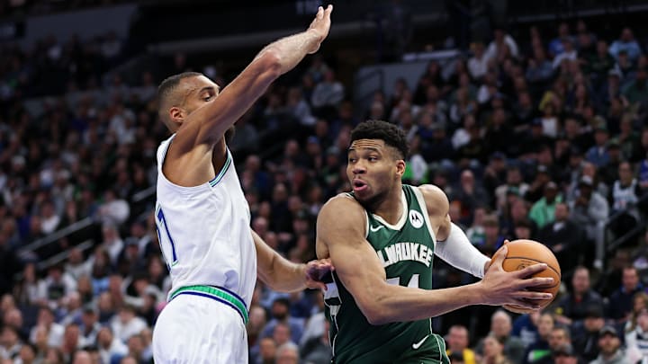 Feb 23, 2024; Minneapolis, Minnesota, USA; Milwaukee Bucks forward Giannis Antetokounmpo (34) works around Minnesota Timberwolves center Rudy Gobert (27) during the first half at Target Center. Mandatory Credit: Matt Krohn-Imagn Images