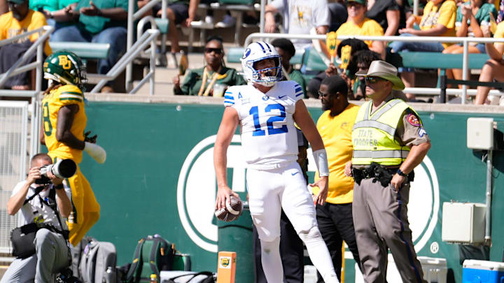 Sep 28, 2024; Waco, Texas, USA;  Brigham Young Cougars quarterback Jake Retzlaff (12) celebrates after scoring a touchdown against the Baylor Bears during the first half at McLane Stadium.