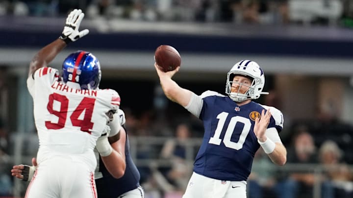 Nov 28, 2024; Arlington, Texas, USA;  Dallas Cowboys quarterback Cooper Rush (10) throws a pass as New York Giants defensive tackle Elijah Chatman (94) defends during the second half at AT&T Stadium. Mandatory Credit: Chris Jones-Imagn Images