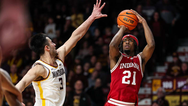 Indiana Hoosiers forward Mackenzie Mgbako (21) shoots as Minnesota Golden Gophers forward Dawson Garcia (3) defends during the second half at Williams Arena.
