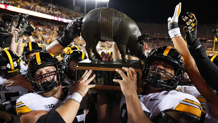 Iowa Hawkeyes offensive lineman Logan Jones (65) and defensive lineman Yahya Black (94) hold up the Floyd of Rosedale trophy after beating the Minnesota. Iowa Hawkeyes offensive lineman Logan Jones (65) and defensive lineman Yahya Black (94) hold up the Floyd of Rosedale trophy after beating the Minnesota.