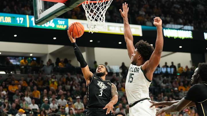 Feb 8, 2025; Waco, Texas, USA; UCF Knights guard Darius Johnson (3) scores a layup as Baylor Bears forward Norchad Omier (15) defends during the first half at Paul and Alejandra Foster Pavilion. Mandatory Credit: Chris Jones-Imagn Images