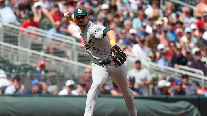Jun 16, 2024; Minneapolis, Minnesota, USA; Oakland Athletics third baseman J.D. Davis (5) throws the ball to first base to get out Minnesota Twins left fielder Willi Castro (50) during the seventh inning of game one of a double header at Target Field. Mandatory Credit: Matt Krohn-USA TODAY Sports