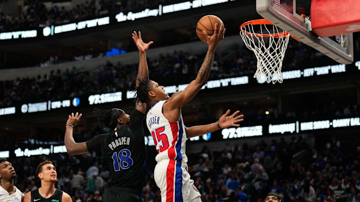 Apr 12, 2024; Dallas, Texas, USA; Detroit Pistons guard Marcus Sasser (25) scores a layup against Dallas Mavericks forward Olivier-Maxence Prosper (18) during the second half at American Airlines Center. Mandatory Credit: Chris Jones-USA TODAY Sports