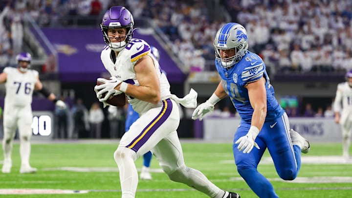 Dec 24, 2023; Minneapolis, Minnesota, USA; Minnesota Vikings tight end Johnny Mundt (86) catches a pass while Detroit Lions linebacker Malcolm Rodriguez (44) defends during the fourth quarter at U.S. Bank Stadium.