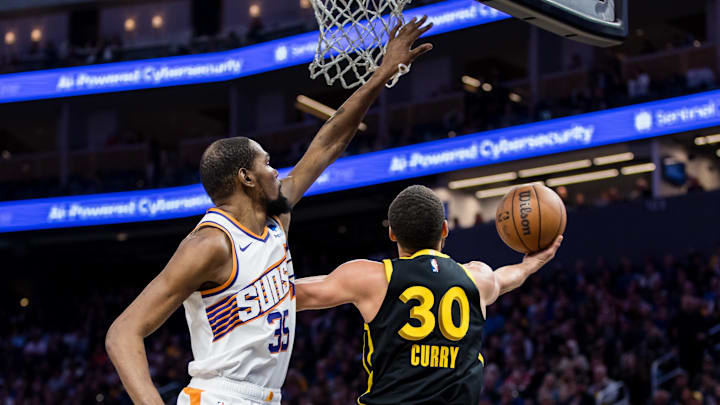  Phoenix Suns forward Kevin Durant (35) defends against Golden State Warriors guard Stephen Curry (30) during the second half at Chase Center. Mandatory Credit: John Hefti-Imagn Images