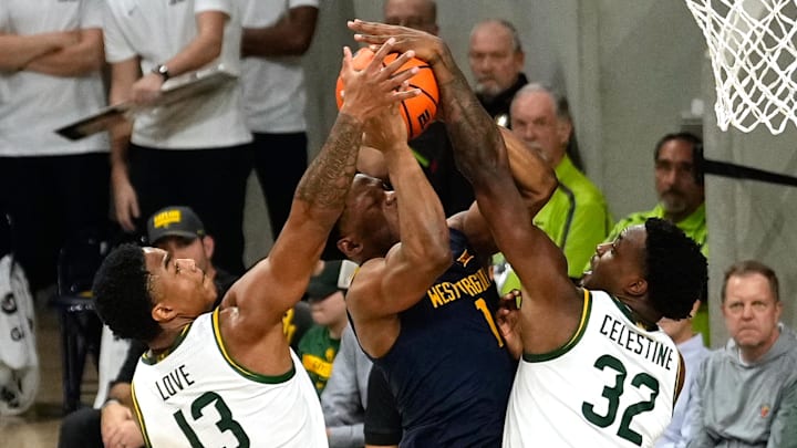 Feb 15, 2025; Waco, Texas, USA;  West Virginia Mountaineers guard Joseph Yesufu (1) has his shot blocked by Baylor Bears guard Jalen Celestine (32) during the second half at Paul and Alejandra Foster Pavilion. Mandatory Credit: Chris Jones-Imagn Images