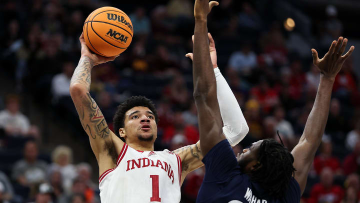 Mar 14, 2024; Minneapolis, MN, USA; Indiana Hoosiers center Kel'el Ware (1) shoots as Penn State Nittany Lions forward Qudus Wahab (22) defends during the first half at Target Center. Mandatory Credit: Matt Krohn-USA TODAY Sports