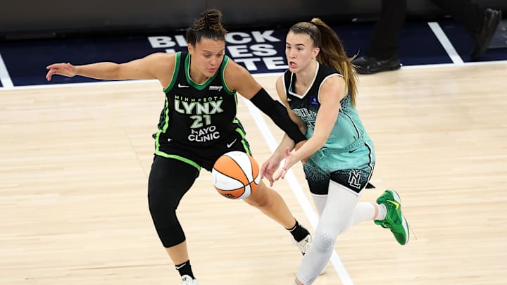 Oct 16, 2024; Minneapolis, Minnesota, USA; New York Liberty guard Sabrina Ionescu (20) passes as Minnesota Lynx guard Kayla McBride (21) defends during the first half of game three of the 2024 WNBA Finals at Target Center. Mandatory Credit: Matt Krohn-Imagn Images
