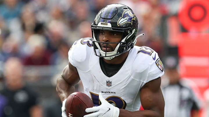 Sep 25, 2022; Foxborough, Massachusetts, USA; Baltimore Ravens receiver Devin Duvernay (13) runs the ball during the first half against the New England Patriots at Gillette Stadium. Mandatory Credit: Paul Rutherford-Imagn Images