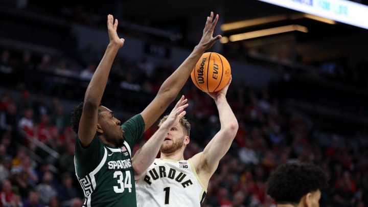 Mar 15, 2024; Minneapolis, MN, USA; Purdue Boilermakers forward Caleb Furst (1) shoots as Michigan State Spartans forward Xavier Booker (34) defends during the first half at Target Center. Mandatory Credit: Matt Krohn-USA TODAY Sports