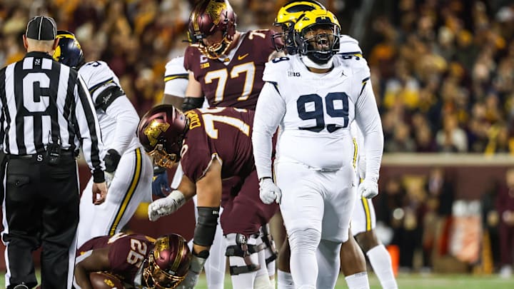 Oct 7, 2023; Minneapolis, Minnesota, USA; Michigan Wolverines defensive lineman Cam Goode (99) celebrates a tackle against the Minnesota Golden Gophers during the second quarter at Huntington Bank Stadium. Mandatory Credit: Matt Krohn-Imagn Images